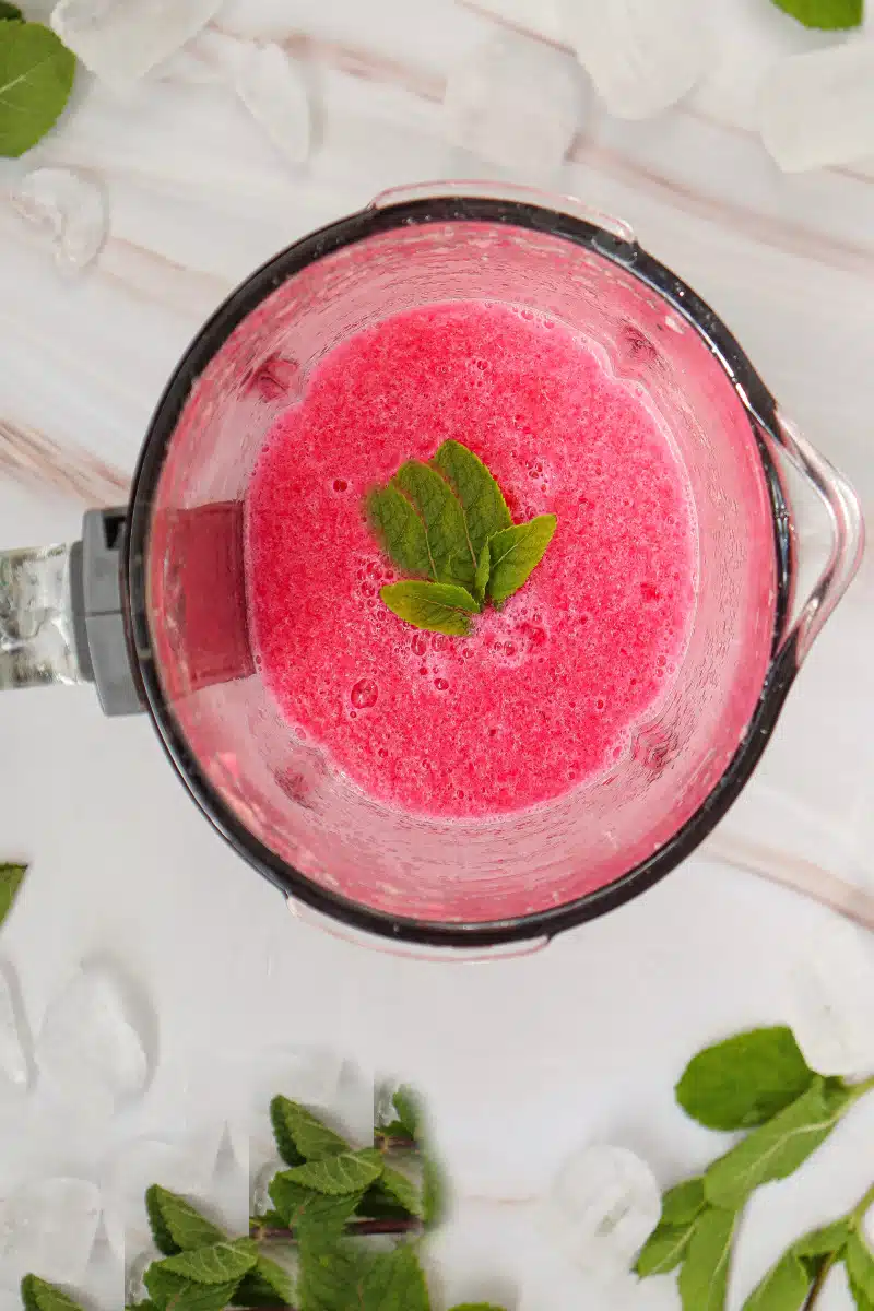adding fresh mint to pureed watermelon