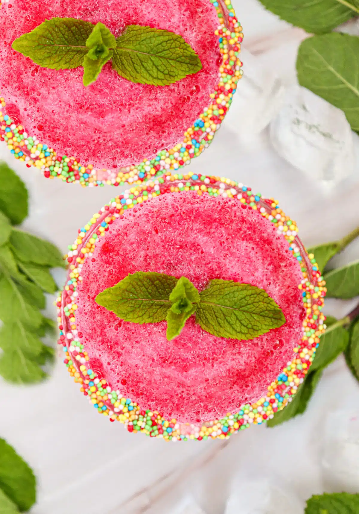 overhead photo of two glasses of watermelon cocktail with fresh mint