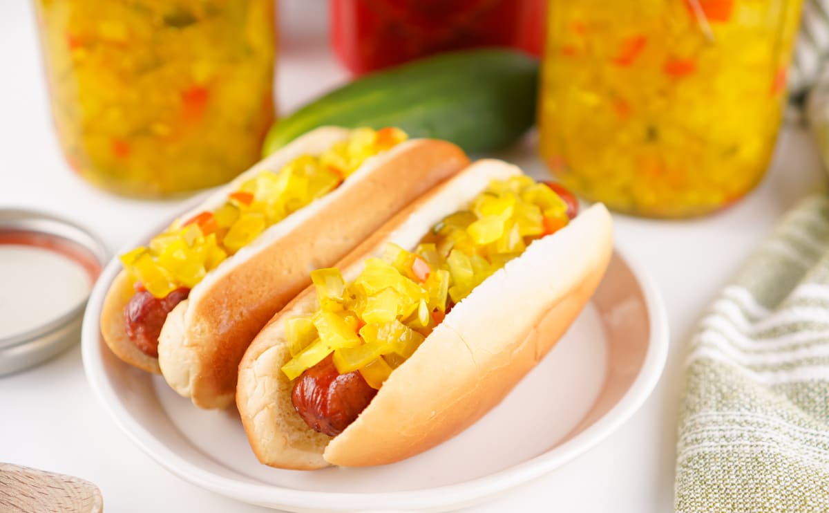 two hot dogs topped with sweet relish