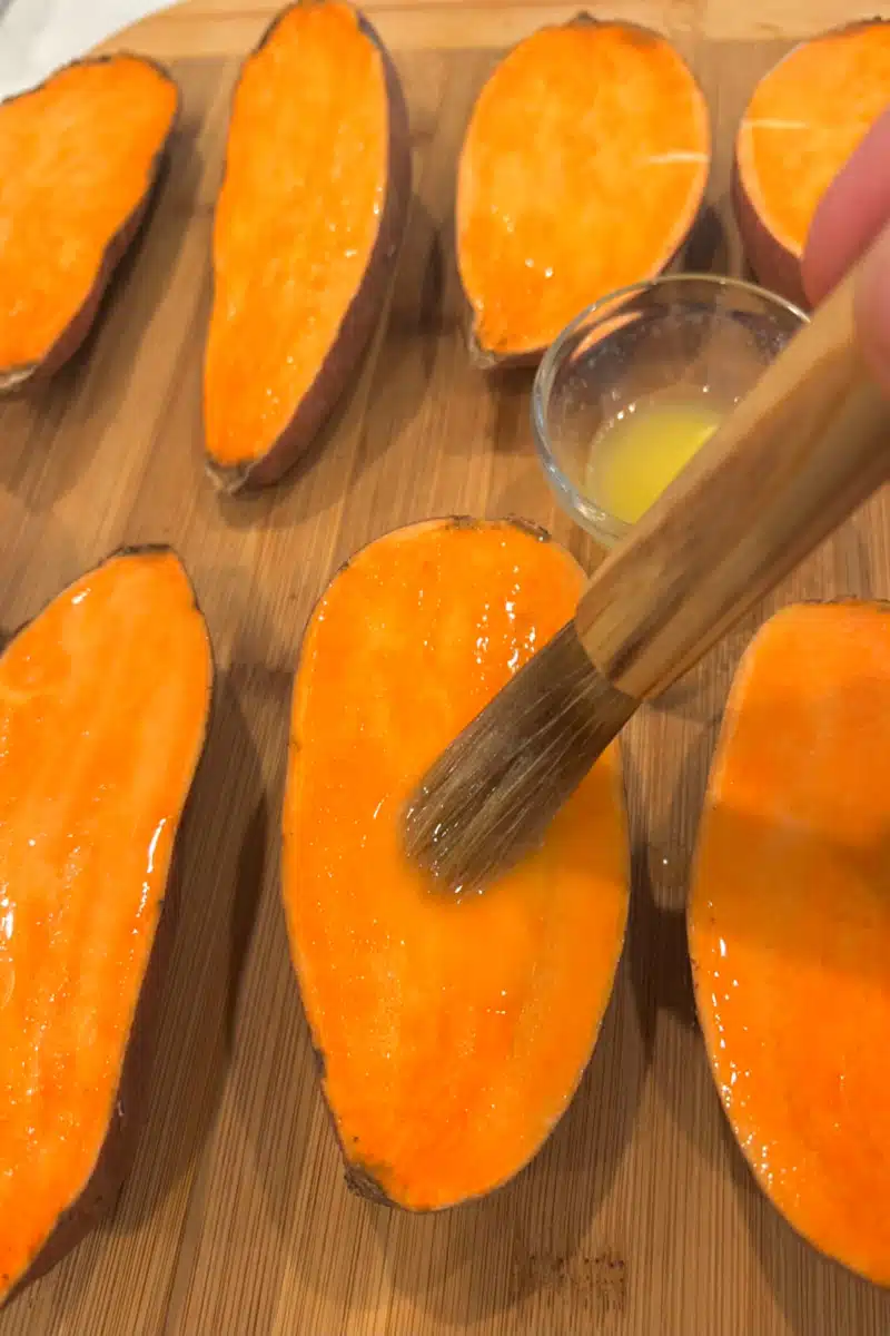 brushing sweet potato halves with melted butter