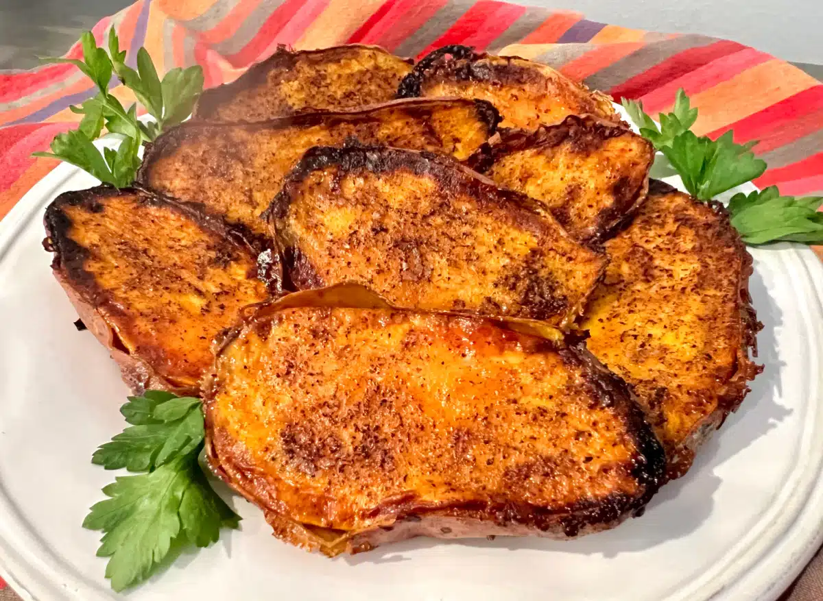 cinnamon sugar sweet potatoes on a round dish with fresh parsley