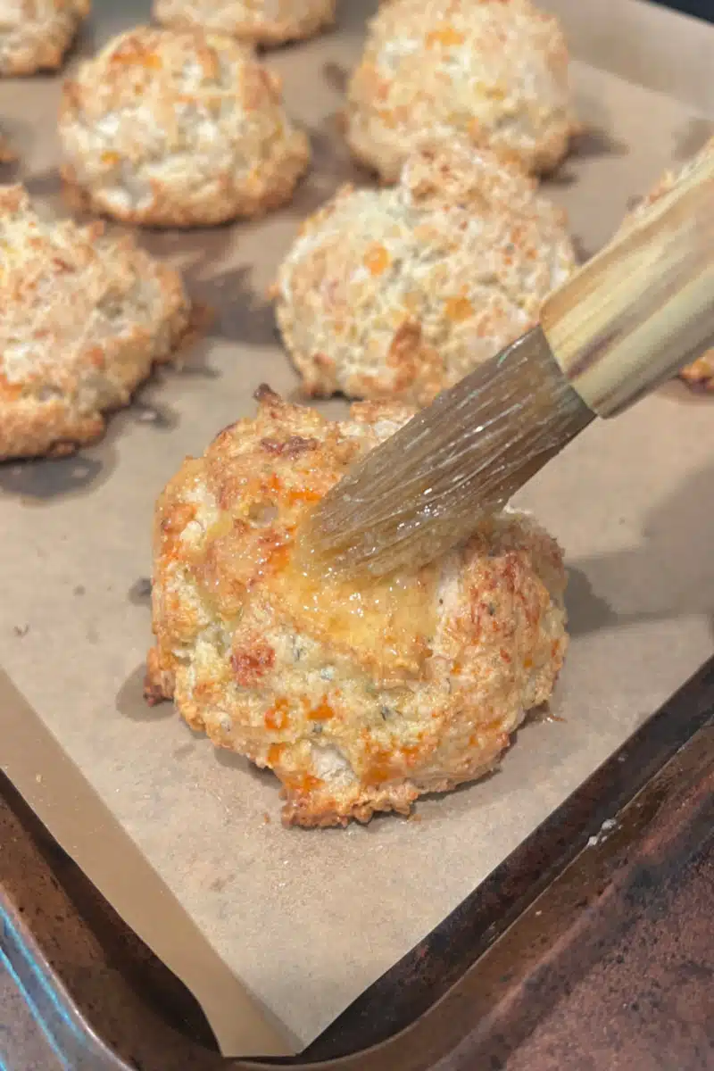 brushing biscuits with melted butter