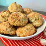 garlic biscuits in a bowl with a pretty napkin