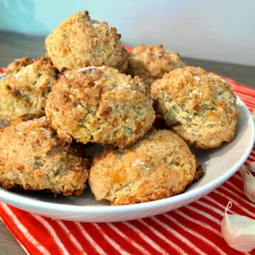 garlic biscuits in a bowl with a pretty napkin