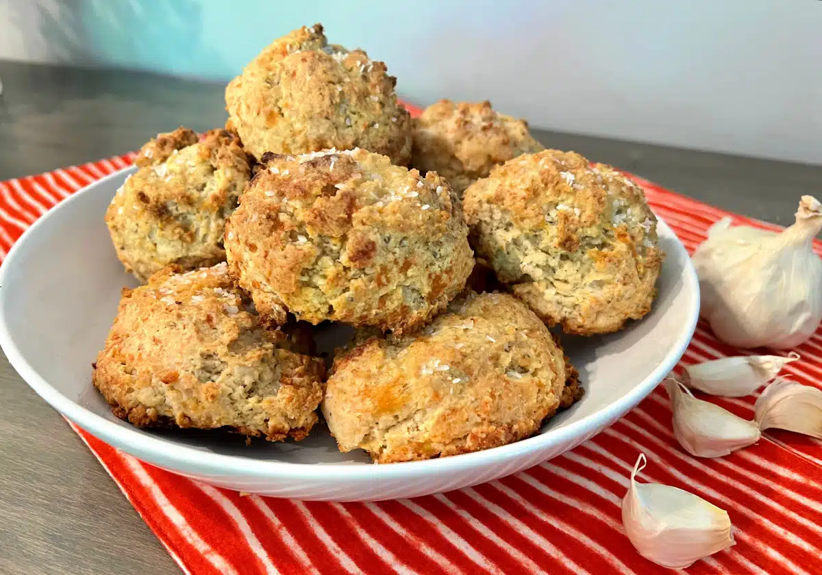 garlic biscuits in a bowl with a pretty napkin