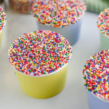 five dot cakes in colorful cups