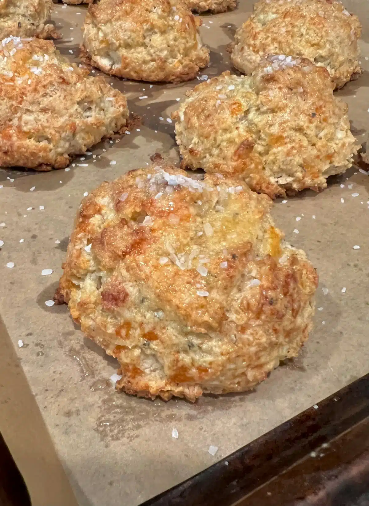 close up of baked garlic biscuits on a pan