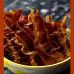 candied bacon in a bowl with text overlay
