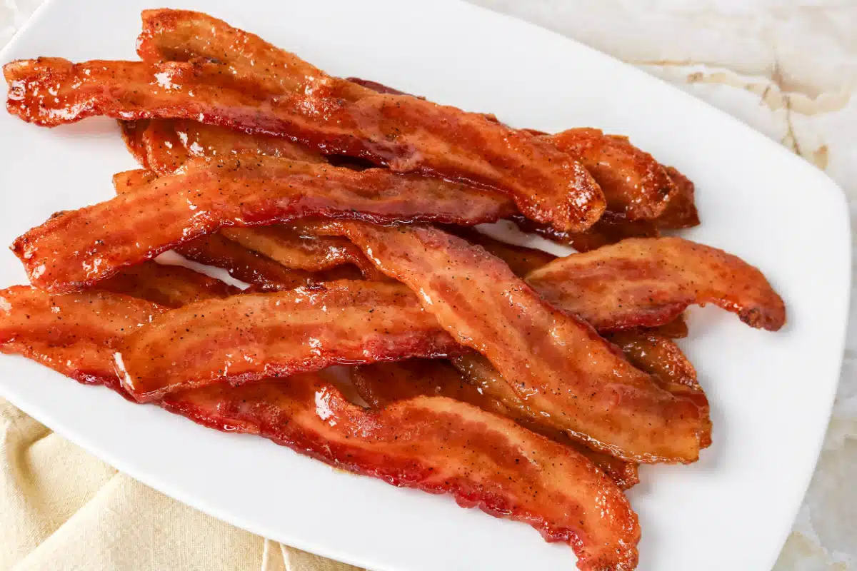 slices of candied bacon on a white plate