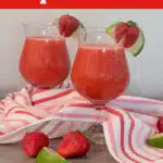 two glasses of strawberry daiquiris with pretty napkin and text overlay