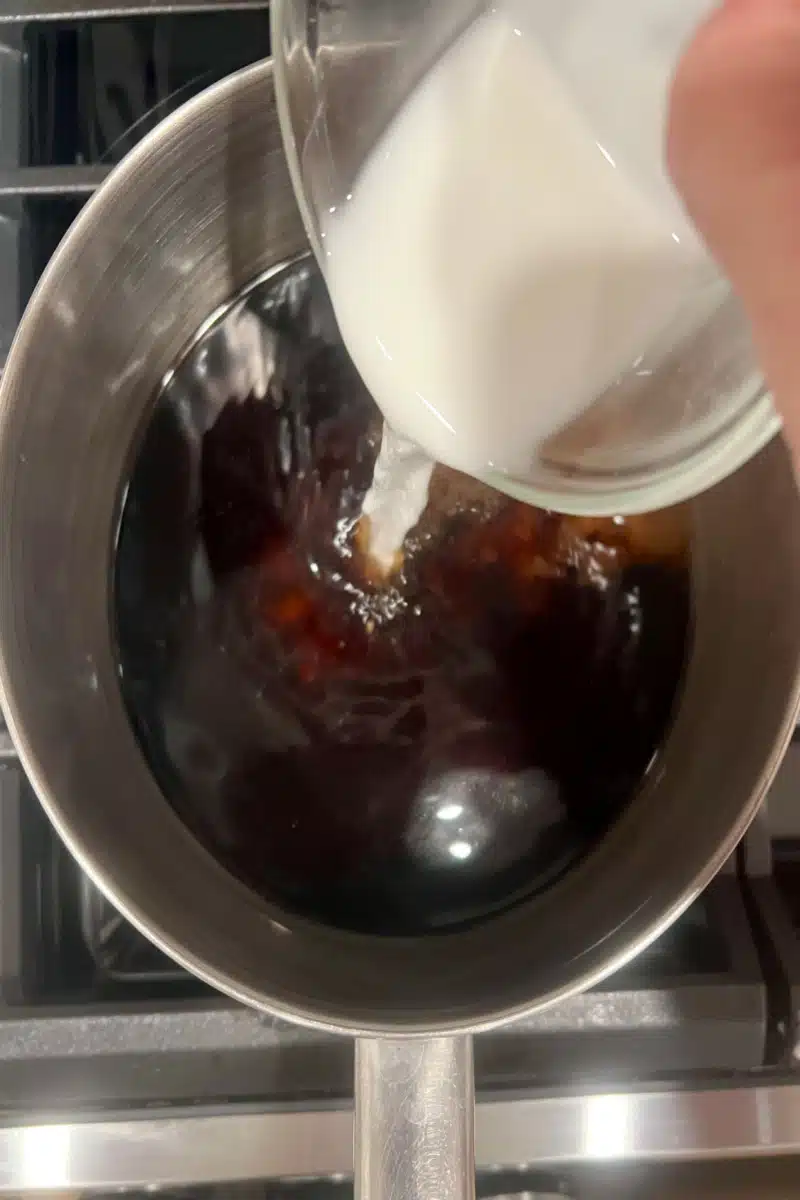 adding cornstarch slurry to make sweet and sour sauce in a saucepot
