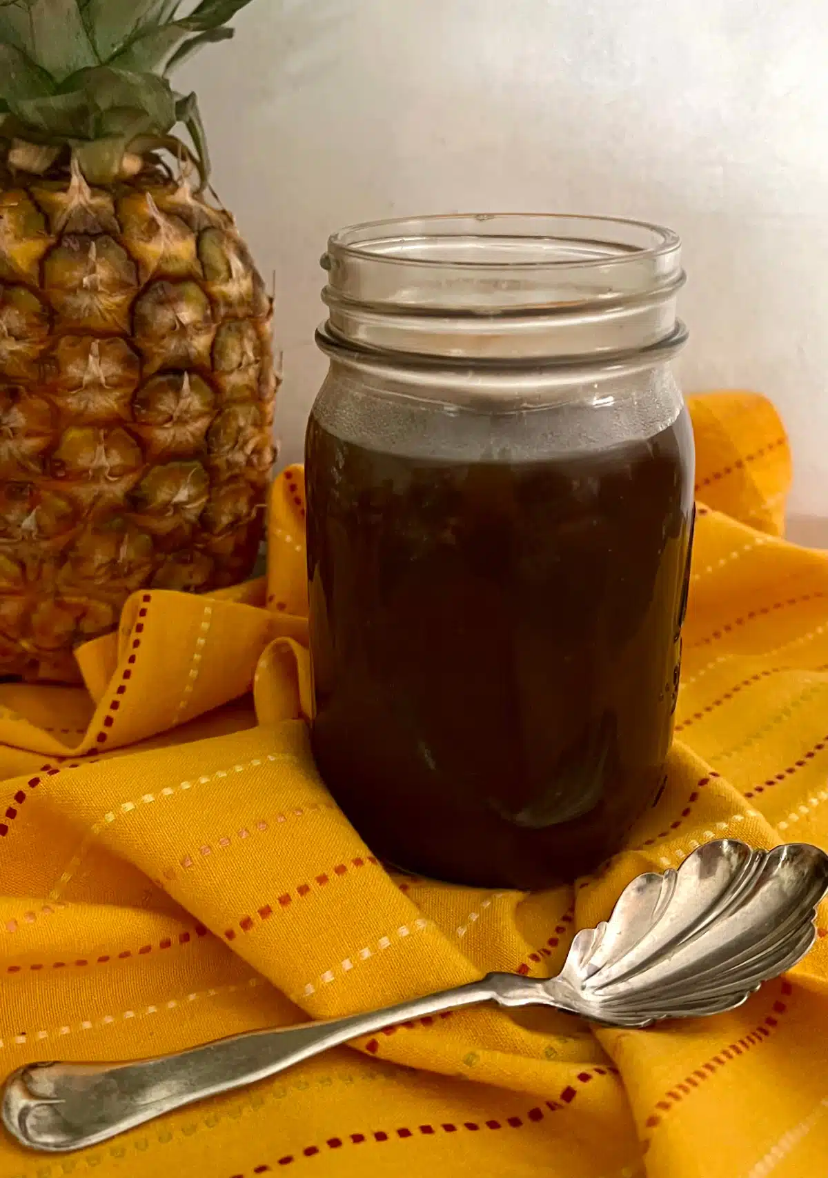sweet and sour sauce in a jar with a pretty spoon