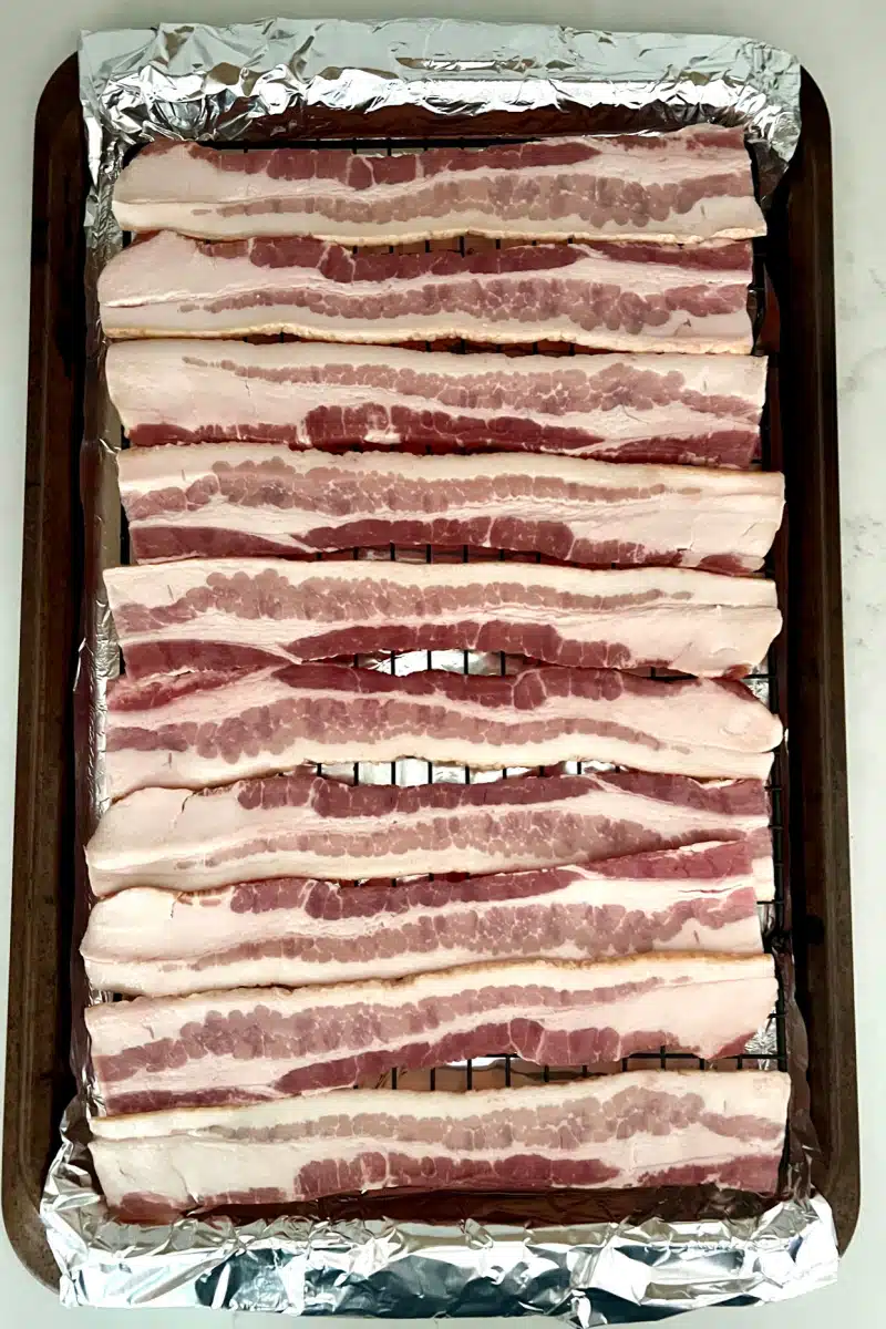 bacon on a rack over a baking sheet