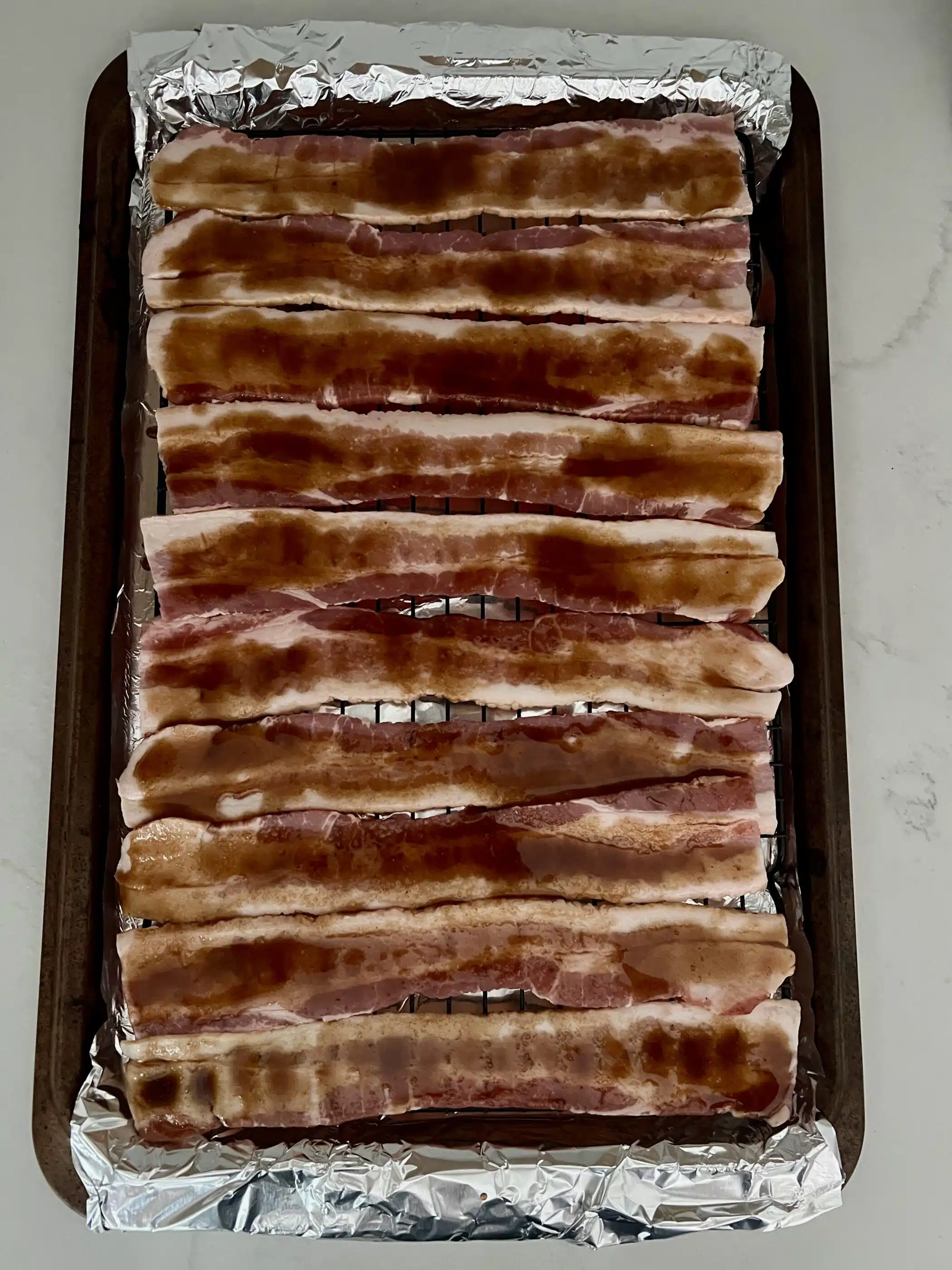 bacon brushed with a maple glaze before cooking