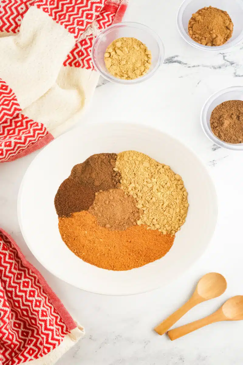 combining spices in a bowl for gingerbread spice blend