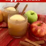 apple cider in glasses with cinnamon stick stirrer and text overlay