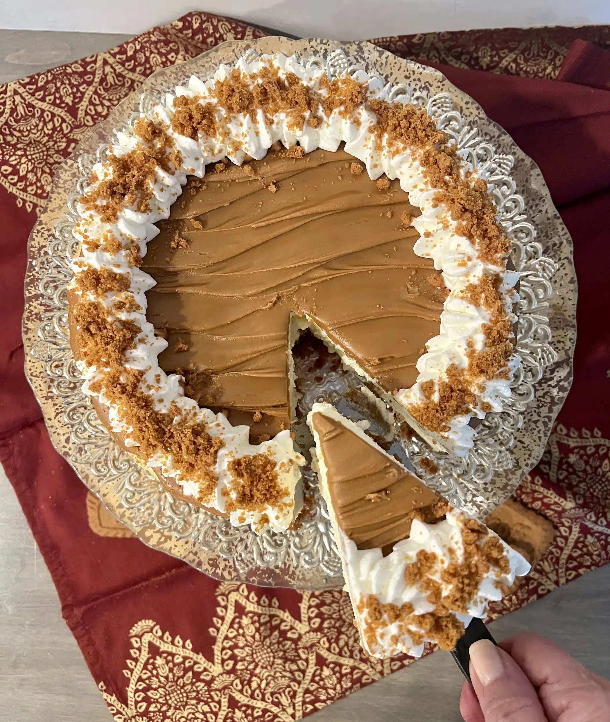 overhead photo of Biscoff cheesecake with slice cut out